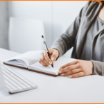 [fpdl.in]_i-prefer-old-school-writing-method-cropped-portrait-busy-woman-making-notes-notebook-looking-computer-screen-during-work-time-office-trying-concentrate-focus-assignment_176420-8697_large